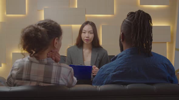 Pretty Asian Female Psychologist Counselling Multiracial Couple During Therapy