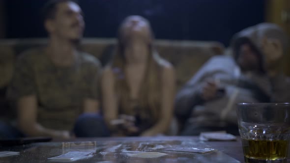 Drug Addicted Youth Using Cocaine at the Table