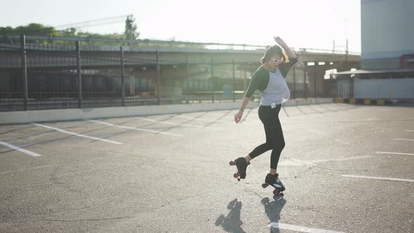 Attractive Beautiful Young Woman Riding Roller Skating and Dancing in the Streets