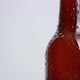 Close-up rotation of beer bottle covered with drops on white background - VideoHive Item for Sale
