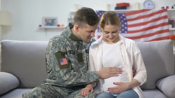 Caring American Soldier Stroking Belly of His Pregnant Wife, Happy Parenthood