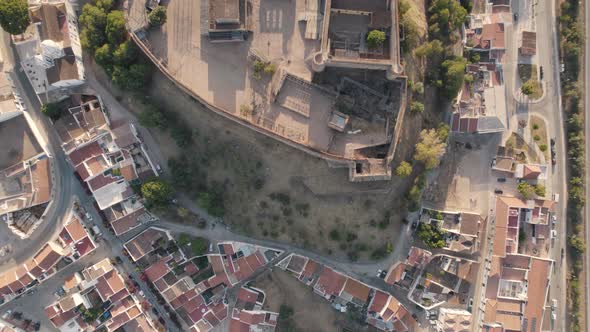 Vertical aerial top down view revealing Castro Marim castle and surrounded parish village.