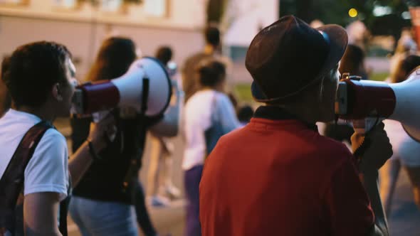 Civil Rights Protest Activists Marching on Streets with Megaphones and Bullhorns