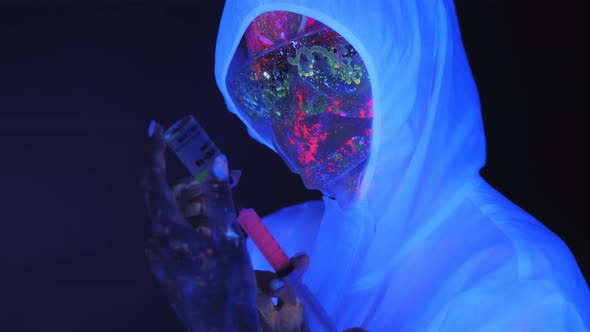 Girl with UV Drawings on Her Skin in White Suit Holding a Syringe of Pink Paint.