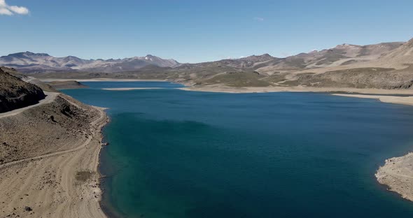 Panning aerial view of the maule lagoon at the pehuenche border crossing between chile and argentina