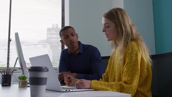 Man and woman discussing at the office