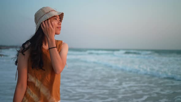 young Asian woman having relaxed and freedom time, walking enjoy on the tropical sea beach