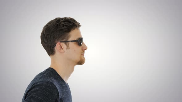 Blind Young Man with a Cane Walking on Gradient Background.