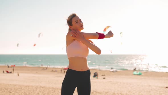 Flexible Caucasian Girl Stretches Arm After an Intensive Running Workout