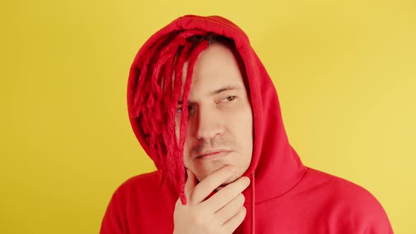 Young Man with Red Dreadlocks in Hood with Thoughtful Look