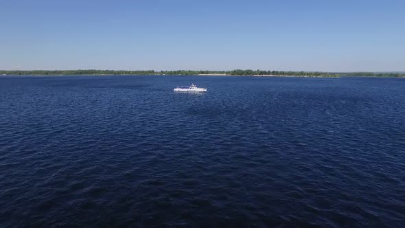 Small Boat is Floating on Wide River in Sunny Summer Day Aerial View