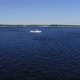 Small Boat is Floating on Wide River in Sunny Summer Day Aerial View - VideoHive Item for Sale