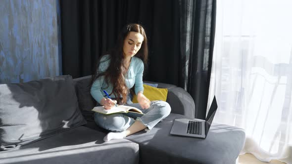 Woman Watching Online Course on Laptop