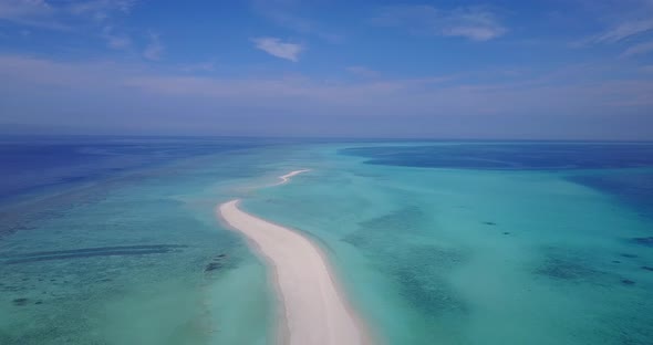 Beautiful overhead tourism shot of a white sandy paradise beach and aqua blue ocean background 