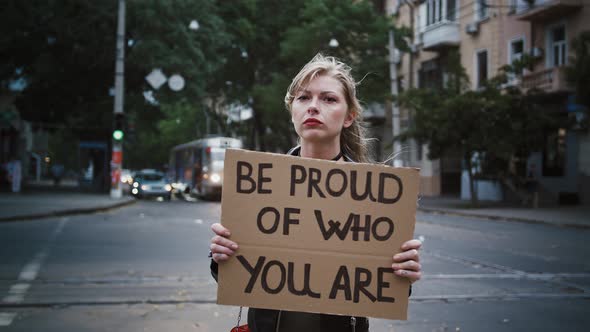 Female Hipster is Raising Up Tablet with Inscription Be Proud of Who you are