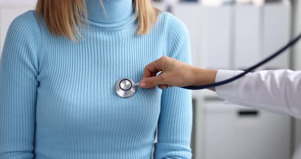 Clinic Doctor Examines Patient Chest with Stethoscope