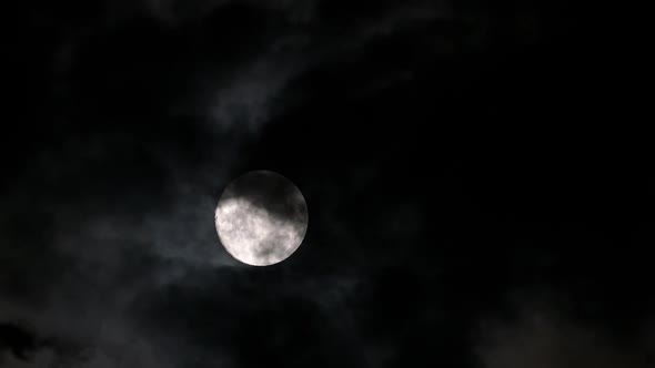 Timelapse with Full Moon Moving Between Clouds