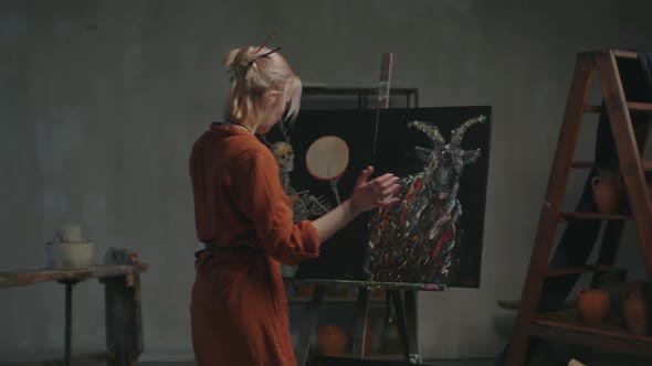 Female Painter Choosing Artwork for Exhibition