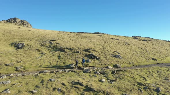 Aerial view of people hiking and climbing Snowdon mount in Wales on a sunny d