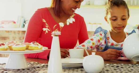 Happy multi-generation family having tea in dining table 4k