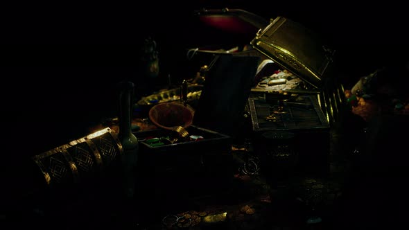 Treasures in a Dark Cave with Coins Diamonds and Gold