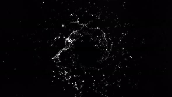 Super Slow Motion Shot of Rotating Water Splash Isolated on Black Background at 1000Fps