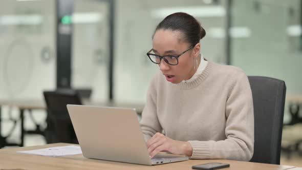 Creative African Woman with Laptop Reacting to Loss