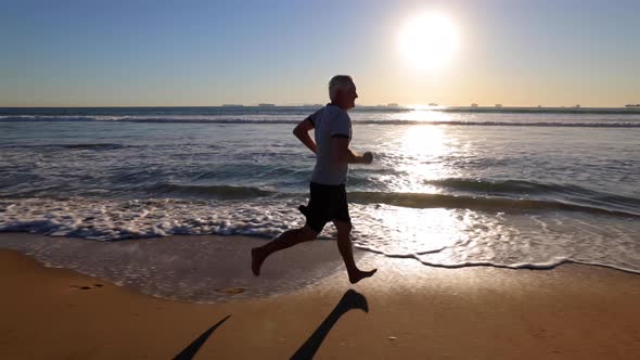 Senior Man Exercising At The  Beach