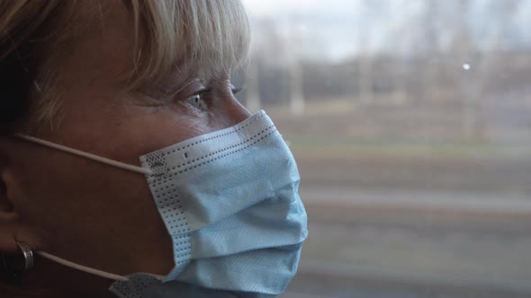 Sad Woman In Protective Mask On Face Ride In Public Transport Close Up