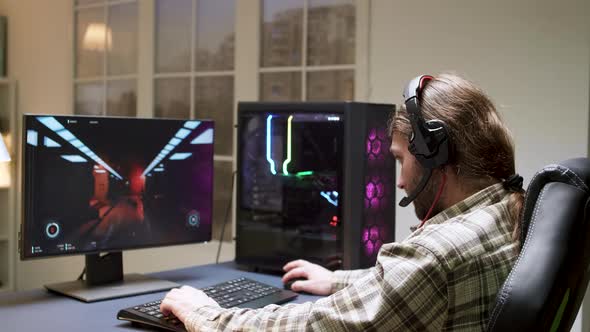 Male Gamer with Long Hair Can't Believe He Lost While Playig Shooter Games