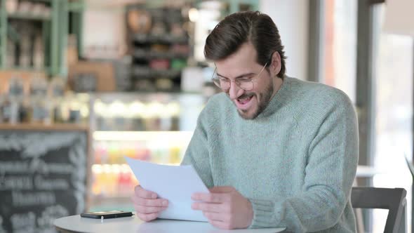 Young Man Having Loss While Reading Paper