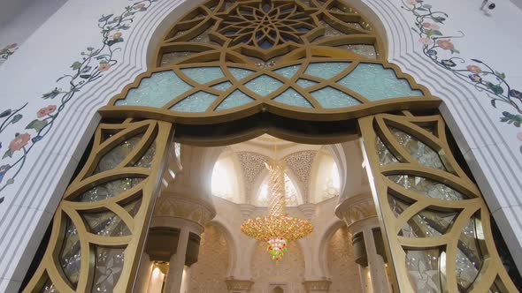 Entering the Sheikh Zayed Grand Mosque in Abu Dhabi through a golden gate