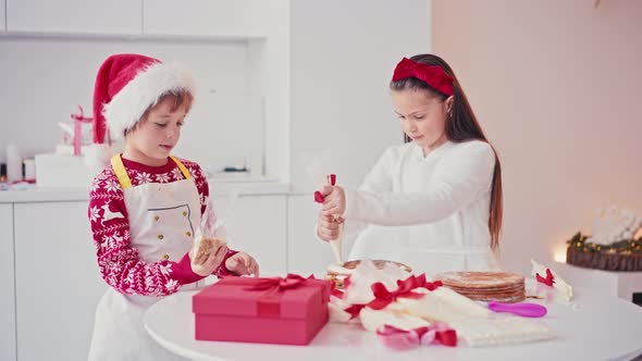 Happy Kids Girl and Boy Making Homemade Cake for Christmas at Light Home Interior