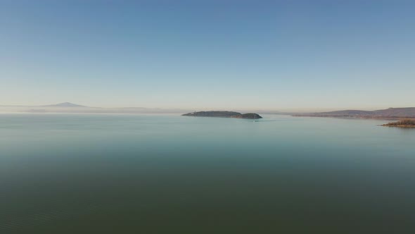 Aerial view of a Sailboat on Passignano sul Trasimeno, Italy.