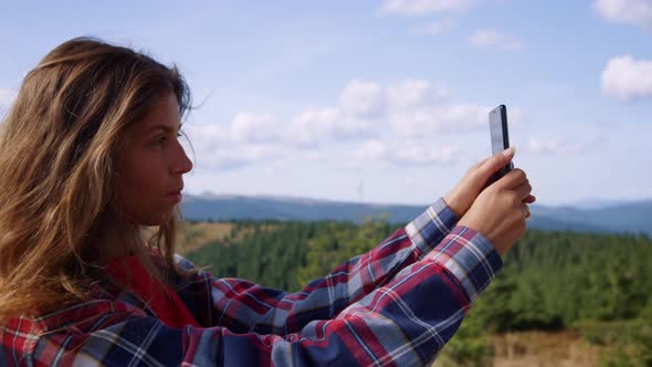 Woman Taking Selfie Photo on Smartphone in Mountains