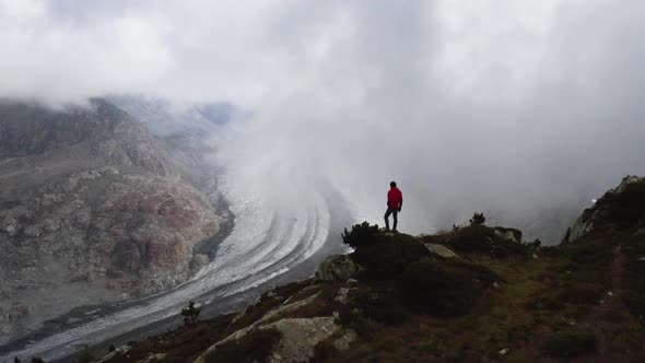 Aerial passes really close from a person that enjoys the view over Aletsch glacier