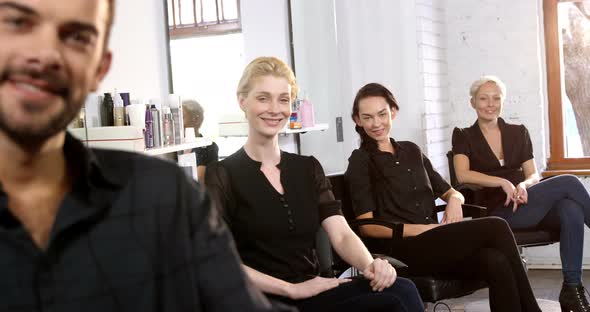 Portrait of smiling hairstylist showing thumbs up