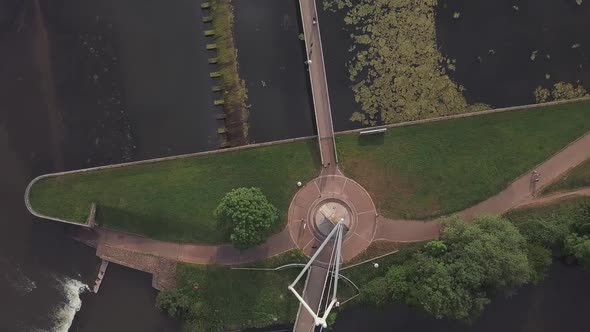 Aerial top shot of a river dam in a UK city