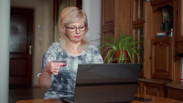 Technology, online shopping and people concept - happy senior 60s woman blonde hair