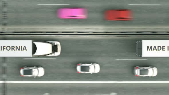 Trucks with MADE IN CALIFORNIA Text Driving Along the Highway alt