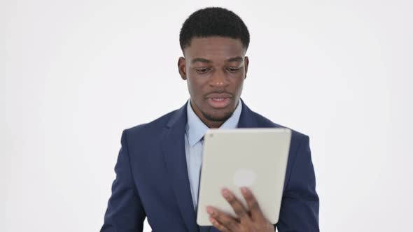 African Businessman Celebrating Success on Tablet on White Background