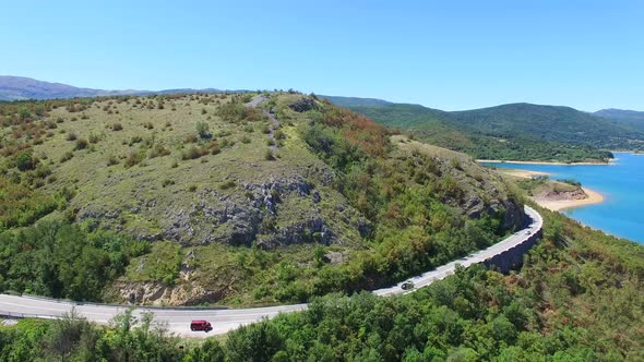 Aerial view of paved road passing artificial lake of Peruca, Croatia