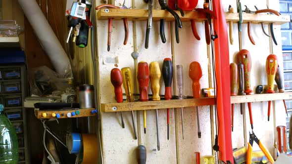 Horologists workshop with clock repairing tools and equipments on wall