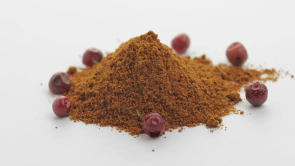 Red Pepper Powder Rotation. Macro Shot Against a White Background