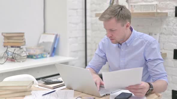 Stressful Businessman Reading Documents