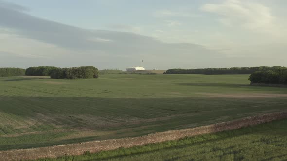 slow low altitude drone shot of industrial factory in the distance