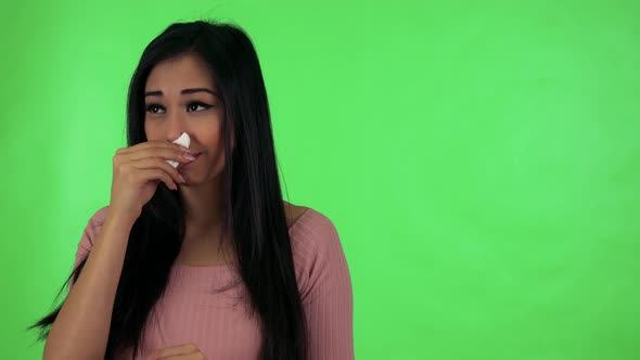 Young Attractive Asian Woman Blows Her Nose Into a Handkerchief - Green Screen Studio