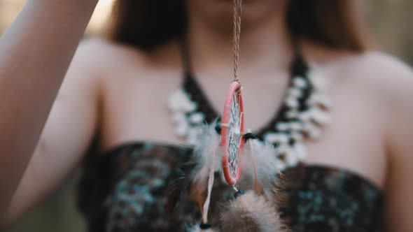 Young Beautiful and Mysterious Woman Holding Dreamcatcher in the Forest. No Face, Slow Motion