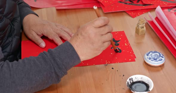 Man Write Chinesse Calligraphy for Lunar New Year