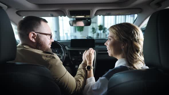 A Married Couple in the Salon of a New Car